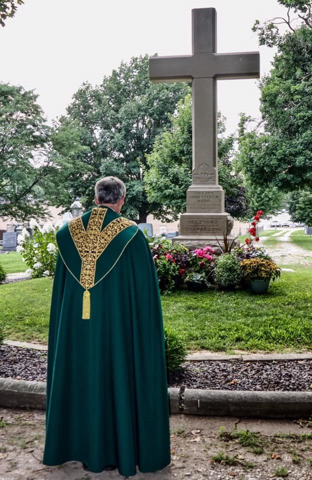 Father Daren Zehnle leads Evening Prayer July 9 at the grave of Fr. Tolton at St. Peter’s Cemetery in Quincy, Illinois.
